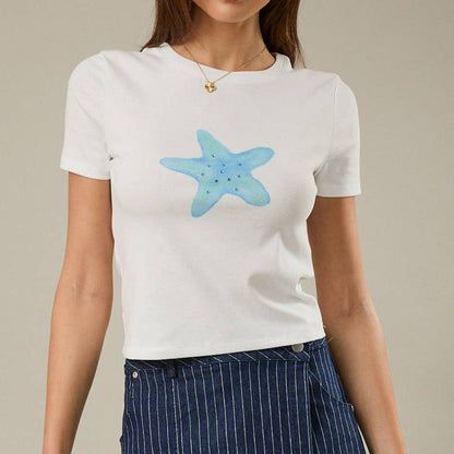 Woman wearing a white t-shirt with a blue starfish design and a navy pinstripe skirt on a beige background