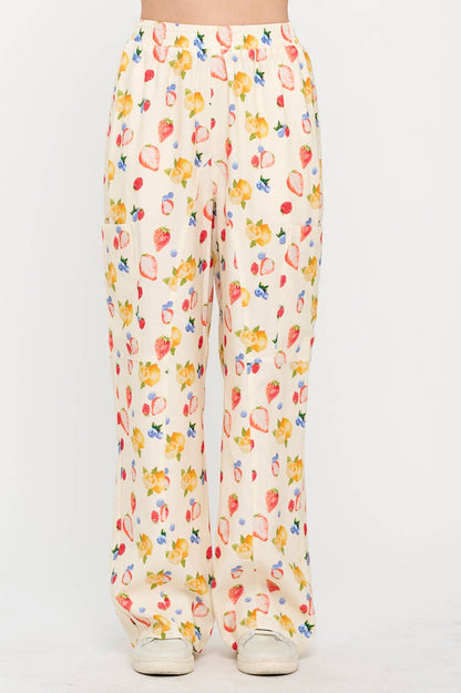 Front view of floral wide-leg pants with a high waist and breezy fabric, featuring a colorful berry and lemon pattern perfect for a casual, chic outfit.